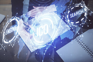 Cryptocurrency hologram over woman's hands writing background. Concept of blockchain. Multi exposure