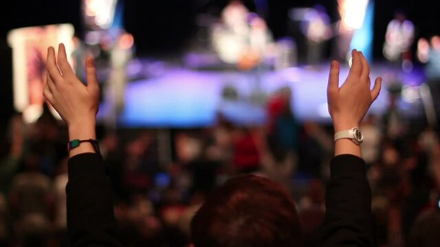 People worshipping with hands in the air at church service or conference. Concert or Gig. Stock Video Clip Footage