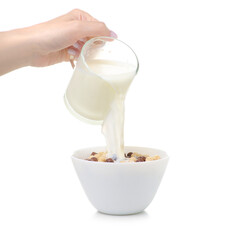 Dry cereal breakfast with glass cup of milk in hand on white background isolation