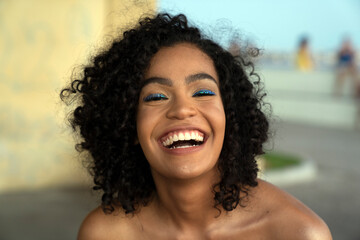 Portrait of a beautiful brazilian woman smiling to the camera outdoors