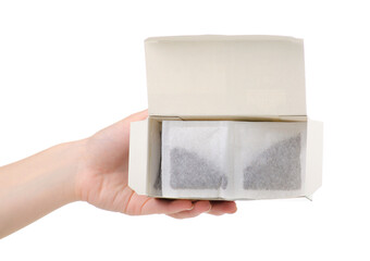 Box with tea bag in hand on white background isolation
