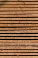 Piles of wooden boards in the sawmill, planking. Warehouse for sawing boards on a sawmill outdoors. Wood timber stack of wooden blanks construction material. Industry.
