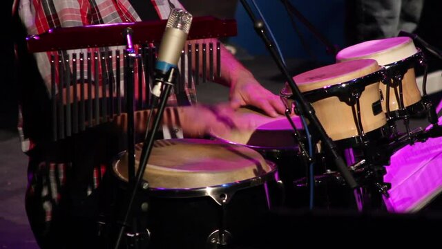 Man playing the bongo drums at a gig or concert. Stock Video Clip Footage