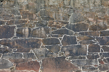 Image of a granite stone coastal wall. Textured background.