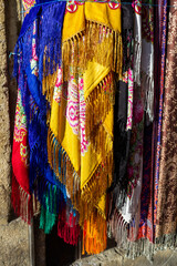 Scarves of different nations and nationalities of all time are for sale in the old city