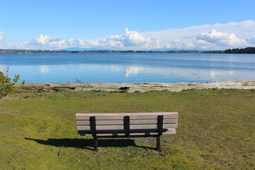 Naklejka na ściany i meble An empty bench with a beautiful bay view 