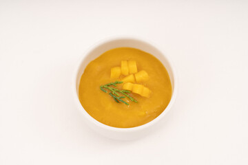 sweet mango sauce in white cup on white background.