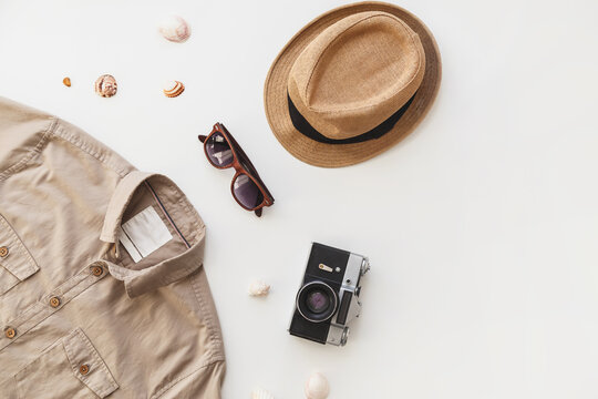 Fashionable male traveler set. Mens shirt and sunglasses isolated on white background. Flat lay, summer style concept.
