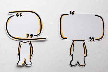 Paper figures with speech bubbles on the white