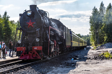 Fototapeta na wymiar Retro train Ruskealsky express in Karelia, Russia
