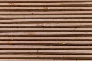Piles of wooden boards in the sawmill, planking. Warehouse for sawing boards on a sawmill outdoors. Wood timber stack of wooden blanks construction material. Industry.