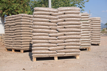Many sacks that are filled with pellets placed on pallets