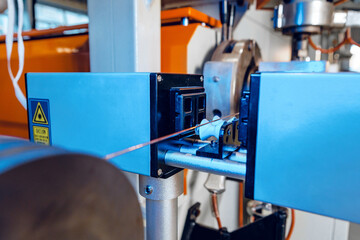 Inside a modern plant producing power electric cables and optical fibers. .Cable manufacturing machine part.