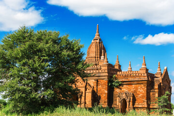 View of a Majestic Ancient Pagoda inside a Forest in Bagan, Myanmar. Beautiful Cloudy Sky, Copy Space 