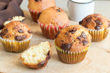Homemade muffins with chocolate on a wooden table