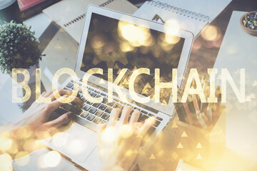 Crypto currency theme hologram with businessman working on computer on background. Concept of...