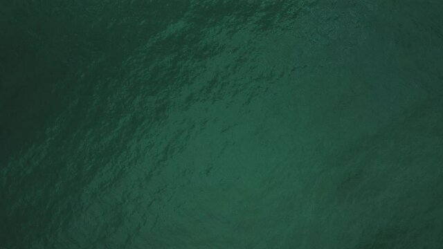 Slow motion cenital drone view of the sea water in Caldes d'Estrach, Spain, Europe..