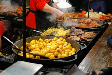 Food booth selling traditional Polish street food at a Christmas Market stall in Krakow, Poland. Traditional Polish street food in Cracow.  