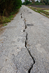 Long deep crack on upcountry old asphalt road.