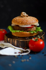 burger with fresh vegetables on a black background