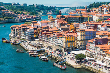 Fototapeta na wymiar Panoramic view of Oporto and the Douro River with typical boats, Portugal.