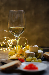 Camembert cheese with red caviar and white wine grapes