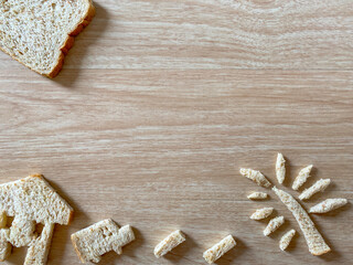 Bread slices that are cut into wheat marks have home symbols and whole wheat bread slices. Smells delicious Placed on a wood grain background Ideas and concepts simple morning, Business. mock up.