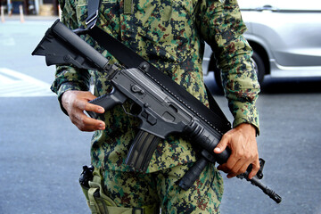 Rifle gun of a soldier in uniform
