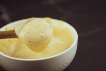 Use wooden spoon scoop of caesar salad dressing