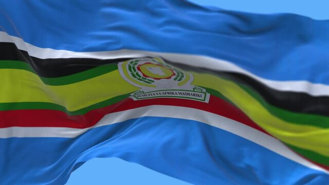 4k East African Community flag;EAC cloth texture slow seamless loop waving with visible wrinkles in wind sky background.A fully digital rendering;animation loops at 20 seconds.