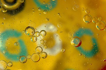 Air bubbles in water against the background of a yellow background with green accents