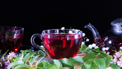 Red hot hibiscus tea in glass mug. Tea time: cup of tea, carcade, karkade, rooibos. Oriental, cozy, ceremony, tradition, japanese, leafy, hygge, autumn, 5 o'clock, afternoon tea