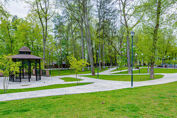 Spring park with stone walkways and benches