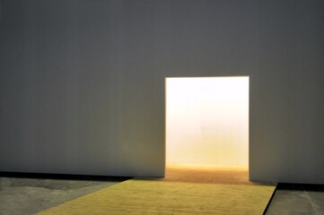 White wall with open doorway to luminous empty space