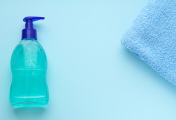 Hand and surface treatment in the house and a Terry cloth for cleaning on a blue background. Selective focus. Space for text. Cleanliness and hygiene. Copy space. Prevention of coronavirus.