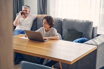 Two smiling family members staying inside together