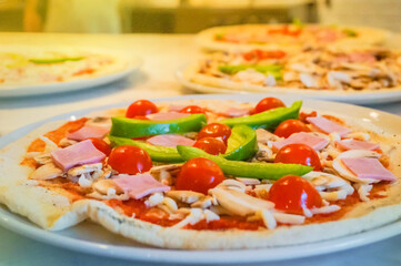 Homemade pizza with tomato and cheese on the table