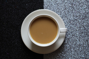 a cup of coffee on the glitter contrast background, modern design, selective focus