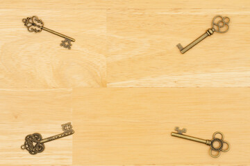 Skeleton keys on wood background with grain texture