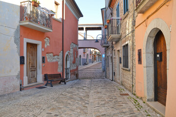 A narrow street between the old houses of Fragneto l'Abate, a medieval village in the Campania region.