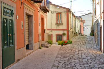 A narrow street between the old houses of San Marco dei Cavoti, a medieval village in the Campania region.
