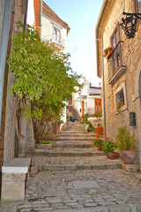 A narrow street between the old houses of San Marco dei Cavoti, a medieval village in the Campania region.
