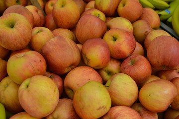 An apple a day - lots of rosy red apples for sale on a market stall.