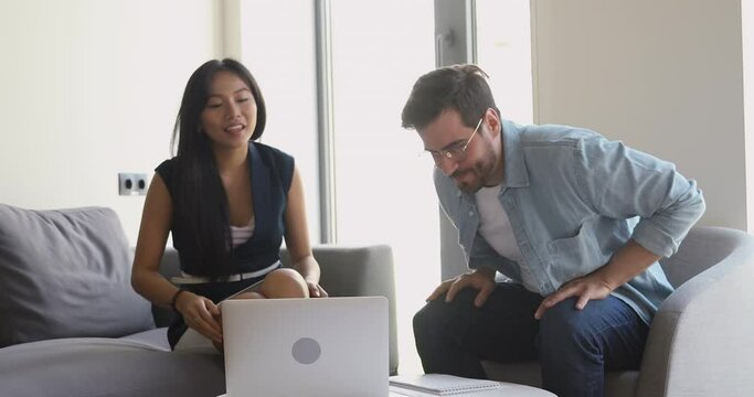 Friendly asian professional manager handshake greeting talking consulting customer at meeting, smiling female broker welcoming client shake hand of male caucasian colleague start teamwork with laptop