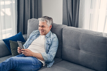 Smiling adult male enjoying time in cozy atmosphere