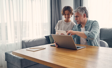 Grey haired man spending time with son