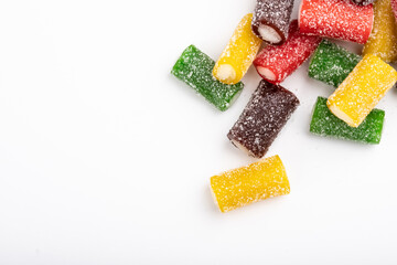 Colorful sour candy licorices. Sweet snack, gummies, jellybeans, gumdrop, gummy candy, unhealthy food. Isolated on white background