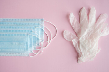 Medical protective mask and rubber gloves lie on a blue background. Anti-virus protection kit against covid-19. Coronavirus pandemic 2019.