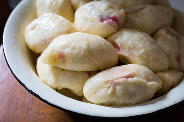 The process of cooking traditional vareniki - textured background. Rural East European cuisine. Dumplings with cottage cheese. Traditional dumplings, pierogi, varenyky