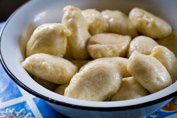 The process of cooking traditional vareniki - textured background. Rural East European cuisine. Dumplings with cottage cheese. Traditional dumplings, pierogi, varenyky